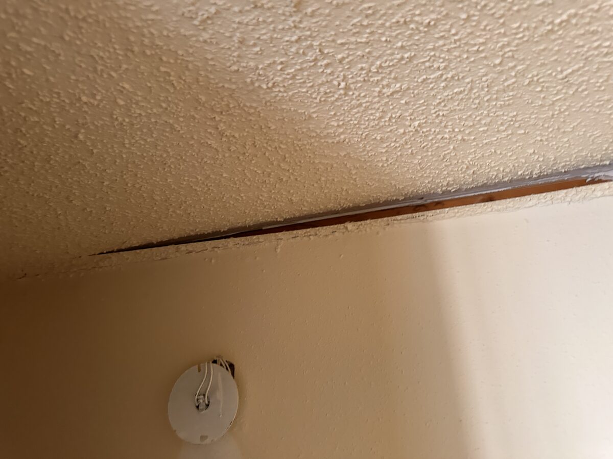 Ceiling pulling away from the wall above a doorbell chime as the home's foundation settles